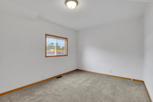 carpeted empty room with baseboards