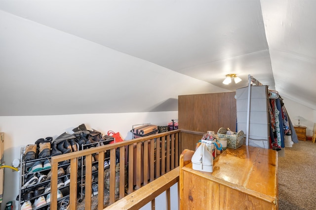 carpeted home office featuring vaulted ceiling