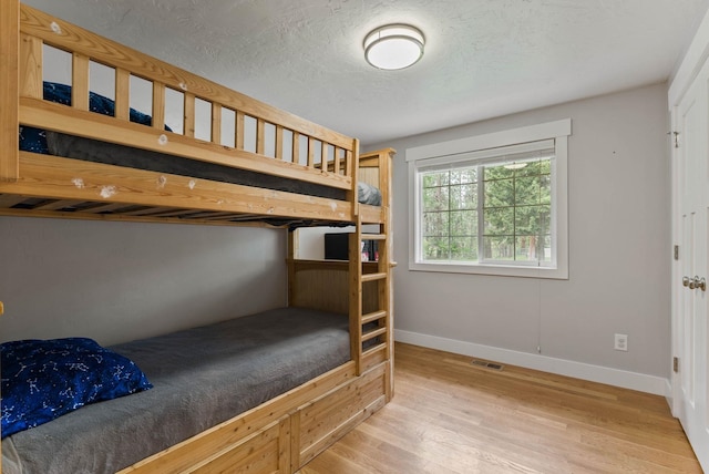 16814 N Tamarac Ln, Nine Mile Falls, WA 99026 - bedroom featuring wood finished floors and baseboards
