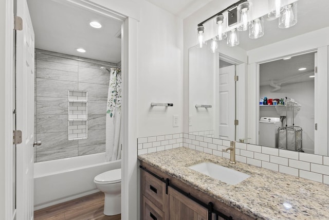 16814 N Tamarac Ln, Nine Mile Falls, WA 99026 - full bathroom with washer / clothes dryer, wood finished floors, decorative backsplash, toilet, and recessed lighting