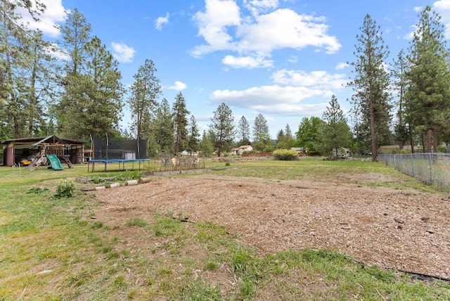 16814 N Tamarac Ln, Nine Mile Falls, WA 99026 - view of yard featuring a trampoline and fence