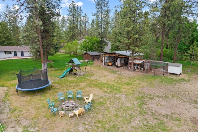 16814 N Tamarac Ln, Nine Mile Falls, WA 99026 - view of green lawn featuring a trampoline, an outdoor structure, a playground, and view of scattered trees