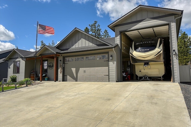 25523 N N Sheridan Rd, Chattaroy, WA 99003 - view of front facade featuring board and batten siding, concrete driveway, and an attached garage