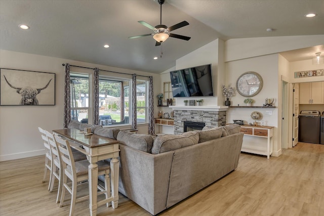 25523 N N Sheridan Rd, Chattaroy, WA 99003 - living room with vaulted ceiling, ceiling fan, a fireplace, independent washer and dryer, and light wood-style floors