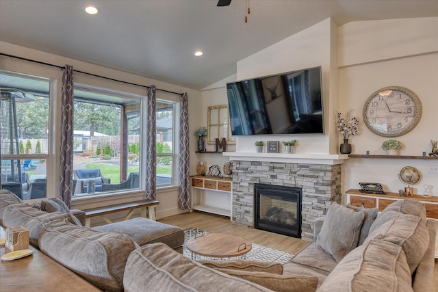 25523 N N Sheridan Rd, Chattaroy, WA 99003 - living room featuring vaulted ceiling, wood finished floors, a stone fireplace, recessed lighting, and ceiling fan