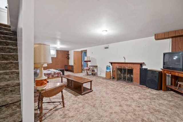 823 N Woodlawn Rd, Spokane Valley, WA 99216 - living room featuring a fireplace, stairway, carpet flooring, and wooden walls