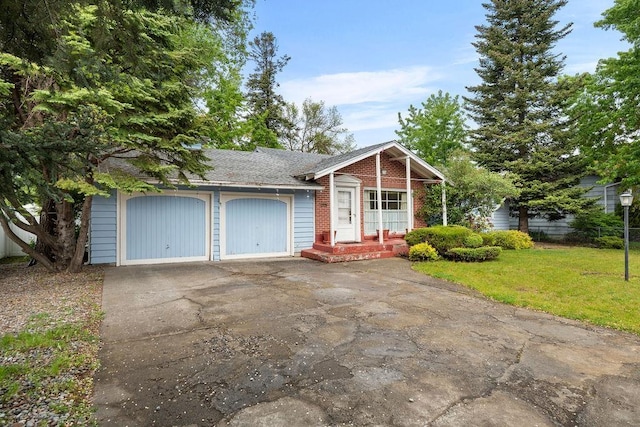 823 N Woodlawn Rd, Spokane Valley, WA 99216 - ranch-style home with asphalt driveway, brick siding, and an attached garage
