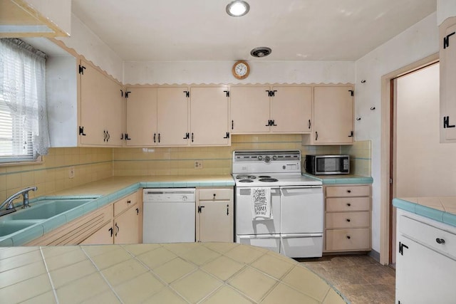 823 N Woodlawn Rd, Spokane Valley, WA 99216 - kitchen with white appliances, tile countertops, a sink, and tasteful backsplash