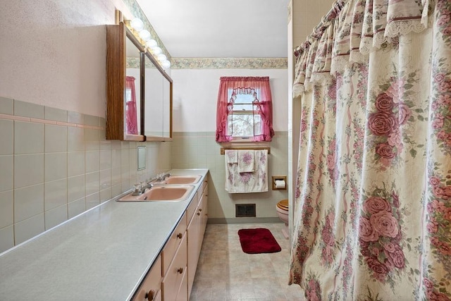 823 N Woodlawn Rd, Spokane Valley, WA 99216 - full bathroom featuring tile walls, vanity, toilet, a wainscoted wall, and a shower with shower curtain