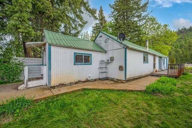 47 Davis Lake Ln, Usk, WA 99180 - back of house with a wooden deck, metal roof, and a lawn