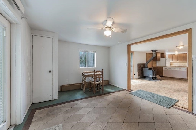 47 Davis Lake Ln, Usk, WA 99180 - dining area with a wood stove, a ceiling fan, and baseboards