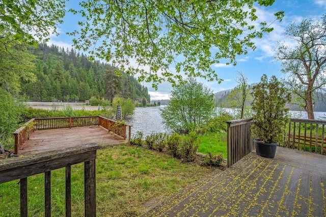 47 Davis Lake Ln, Usk, WA 99180 - view of yard featuring a deck with water view and a wooded view