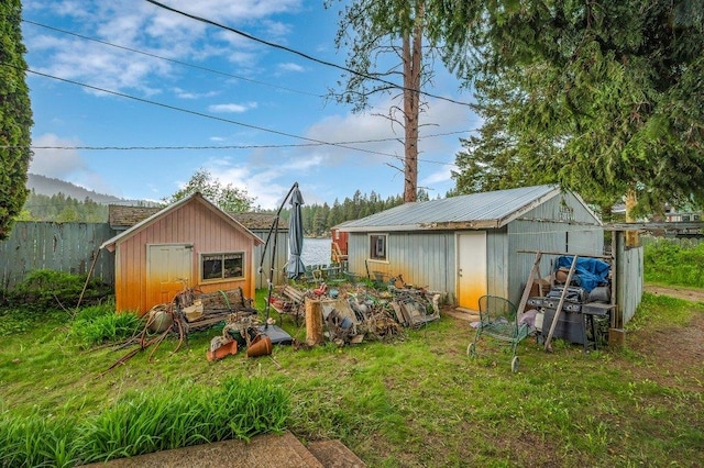 47 Davis Lake Ln, Usk, WA 99180 - view of yard featuring a shed, fence, and an outdoor structure