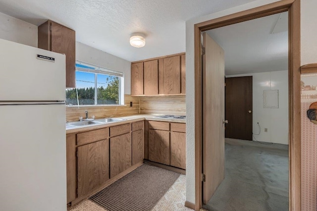 47 Davis Lake Ln, Usk, WA 99180 - kitchen featuring freestanding refrigerator, a sink, light countertops, tasteful backsplash, and electric stovetop