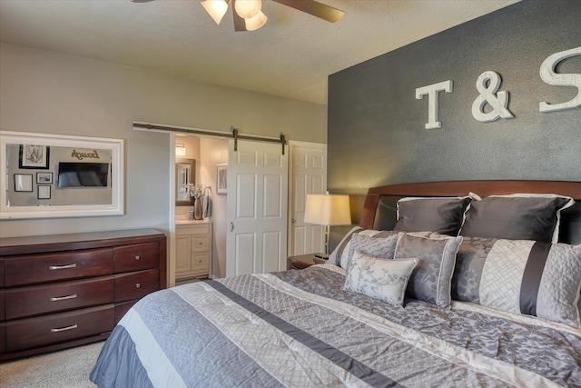 10812 N Fleetwood Ct, Spokane, WA 99208 - carpeted bedroom featuring a barn door and a ceiling fan