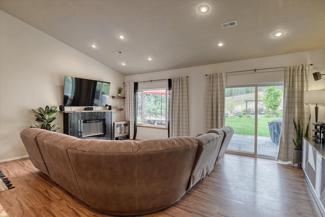 10812 N Fleetwood Ct, Spokane, WA 99208 - living area with a glass covered fireplace, wood finished floors, recessed lighting, vaulted ceiling, and baseboards