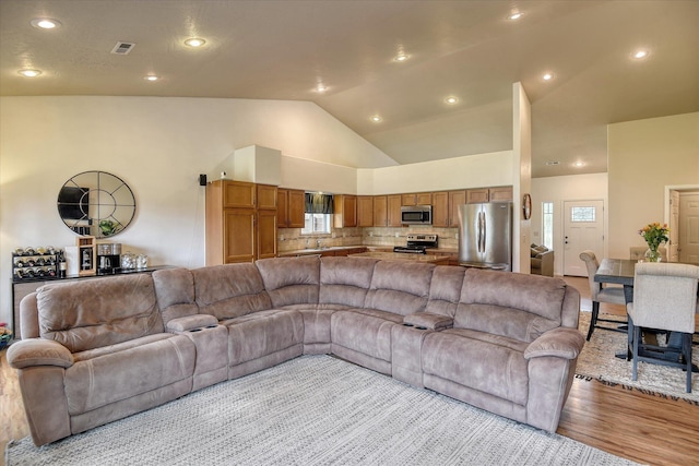 10812 N Fleetwood Ct, Spokane, WA 99208 - living area featuring lofted ceiling and light wood-style flooring