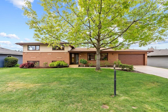 tri-level home featuring brick siding, a garage, driveway, and a front yard