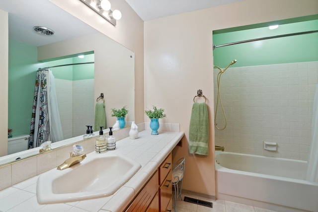 full bathroom with tile patterned flooring, shower / bathtub combination with curtain, and vanity