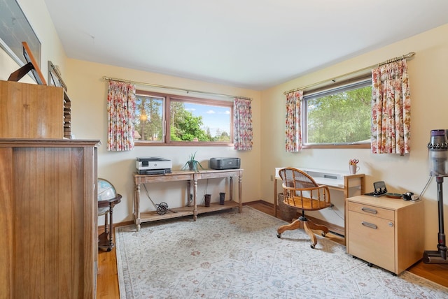 office space with light wood-style floors and baseboards