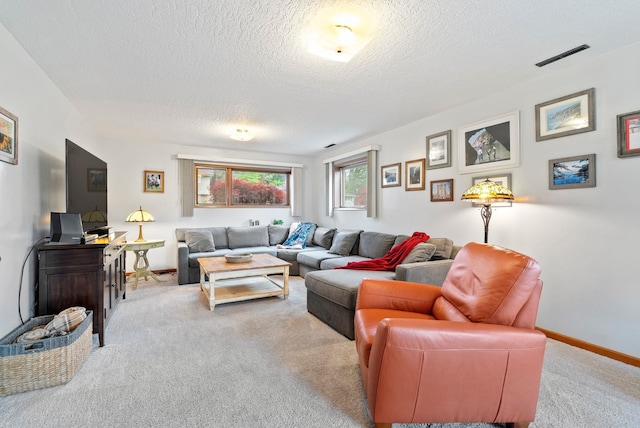 carpeted living room featuring a textured ceiling and baseboards