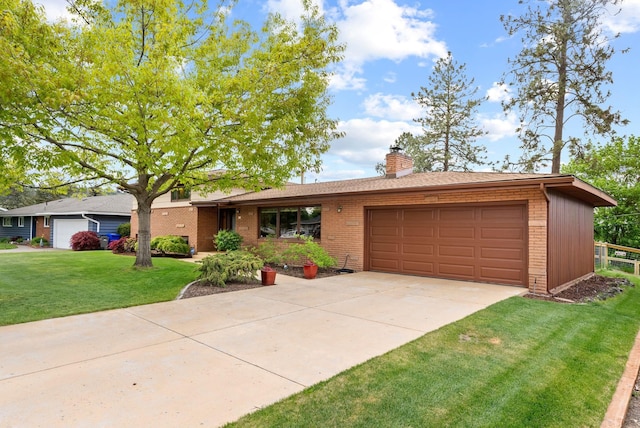 view of front facade with brick siding, a garage, a front lawn, a chimney, and concrete driveway