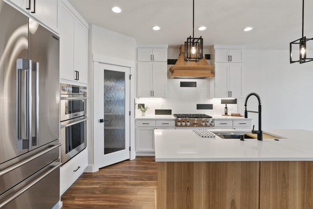 7285 E Columbia Dr, Spokane, WA 99212 - kitchen with stainless steel appliances, a sink, backsplash, white cabinetry, and recessed lighting