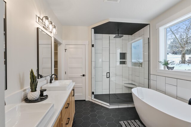 7285 E Columbia Dr, Spokane, WA 99212 - bathroom with a shower stall, double vanity, a soaking tub, and tile patterned floors