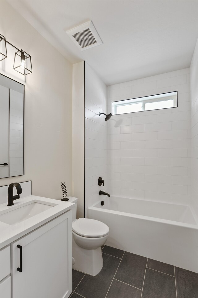 7285 E Columbia Dr, Spokane, WA 99212 - full bathroom with tile patterned flooring, toilet, vanity, and  shower combination