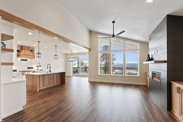 7285 E Columbia Dr, Spokane, WA 99212 - kitchen featuring premium range hood, open shelves, a tile fireplace, ceiling fan, and recessed lighting