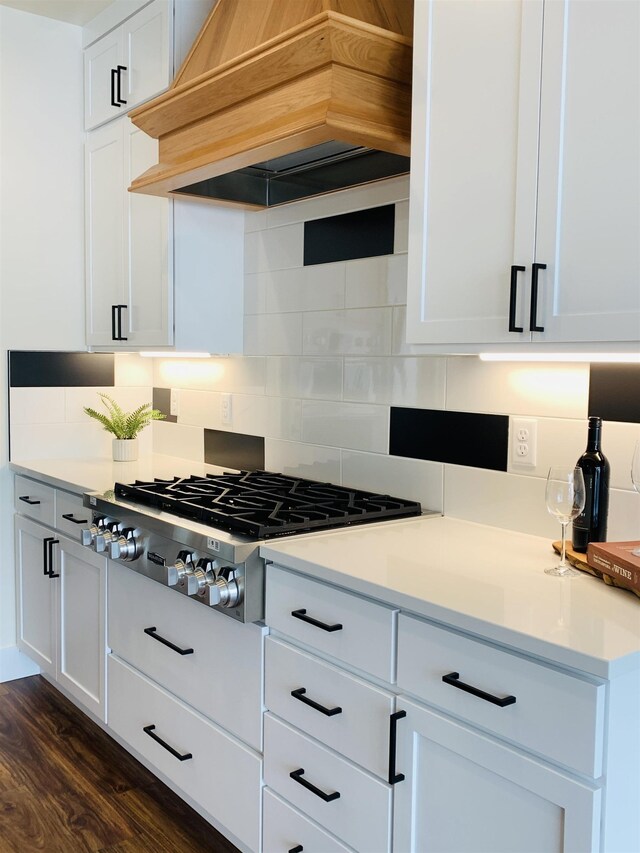 7285 E Columbia Dr, Spokane, WA 99212 - kitchen with premium range hood, stainless steel gas stovetop, white cabinetry, and backsplash