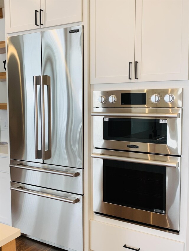 7285 E Columbia Dr, Spokane, WA 99212 - kitchen with stainless steel appliances, white cabinets, and light countertops