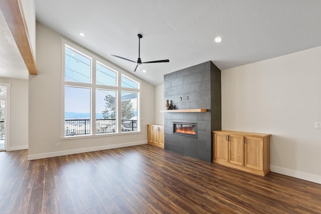 7285 E Columbia Dr, Spokane, WA 99212 - unfurnished living room featuring dark wood-type flooring, a ceiling fan, a large fireplace, baseboards, and recessed lighting