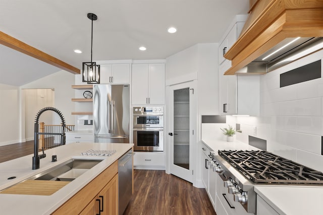 7285 E Columbia Dr, Spokane, WA 99212 - kitchen with stainless steel appliances, a sink, custom exhaust hood, backsplash, and hanging light fixtures