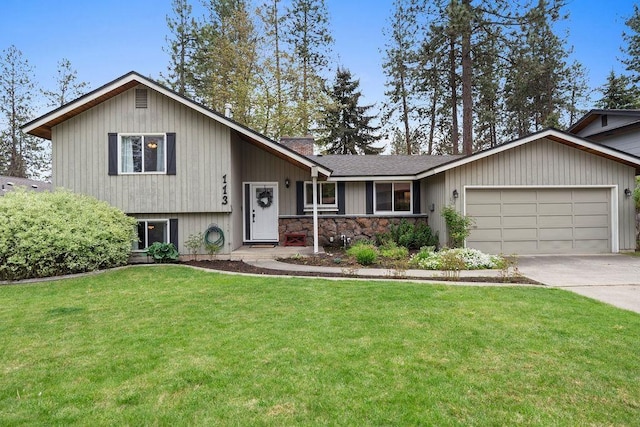 113 W Florence Ave, Spokane, WA 99218 - split level home with a garage, a front yard, driveway, stone siding, and a shingled roof