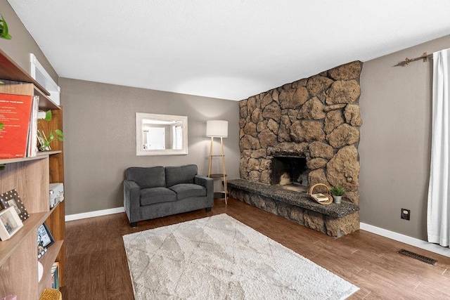 113 W Florence Ave, Spokane, WA 99218 - living room with baseboards, a stone fireplace, and wood finished floors