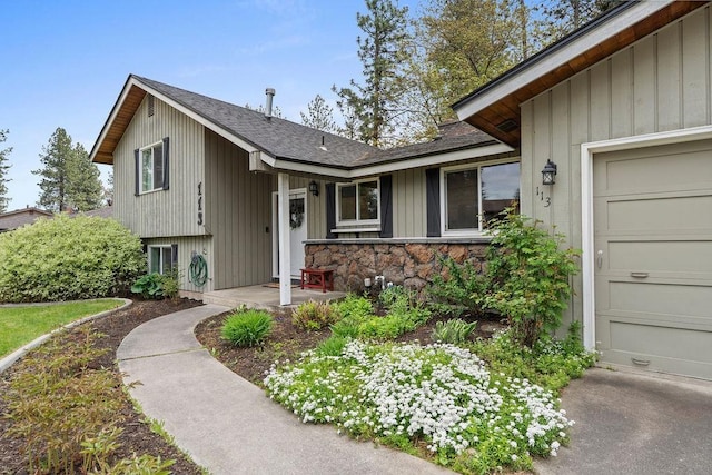 113 W Florence Ave, Spokane, WA 99218 - view of front of home with a shingled roof, board and batten siding, stone siding, and a garage