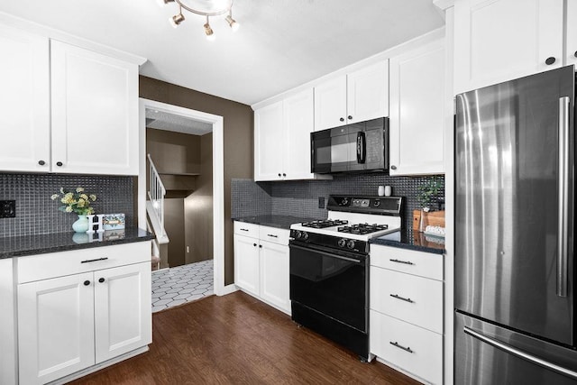 113 W Florence Ave, Spokane, WA 99218 - kitchen with freestanding refrigerator, black microwave, gas range oven, dark wood-type flooring, and tasteful backsplash