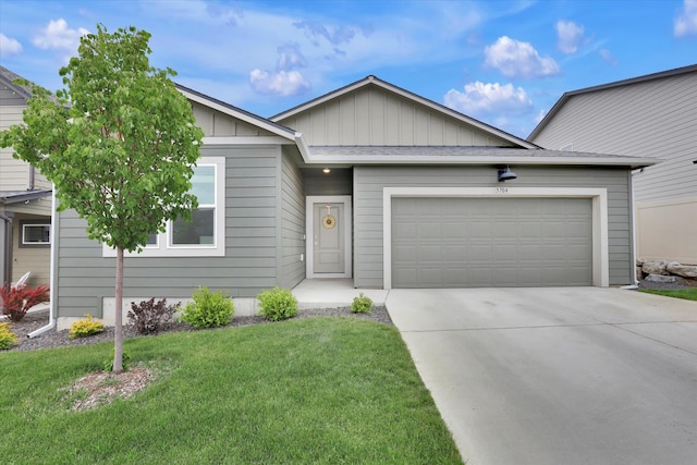 5704 W Jamestown Ln, Spokane, WA 99208 - ranch-style home featuring concrete driveway, an attached garage, board and batten siding, and a front yard