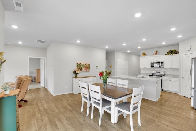 5704 W Jamestown Ln, Spokane, WA 99208 - dining area featuring light wood finished floors, recessed lighting, and baseboards
