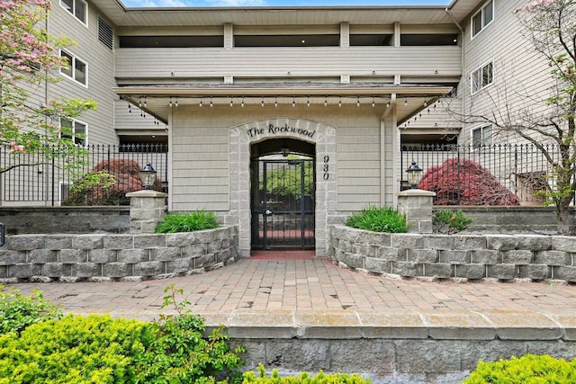930 S Cowley St Unit 113, Spokane, WA 99202 - doorway to property with fence and stone siding