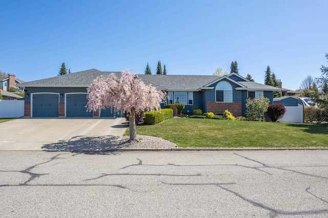 9914 N Comanche Dr, Spokane, WA 99208 - view of front of home featuring a garage, concrete driveway, and brick siding