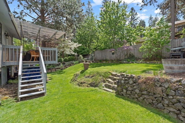 view of yard with stairway and a deck
