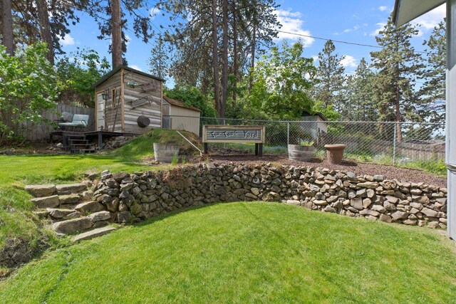 view of yard with an outbuilding and a shed