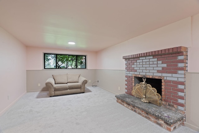 carpeted living room with a fireplace and baseboards