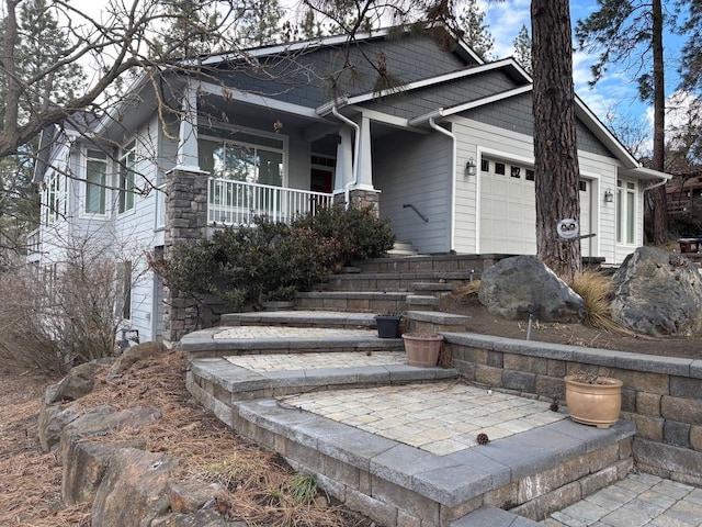 1746 W 14th Ave, Spokane, WA 99204 - craftsman-style house with a porch, a garage, and stone siding