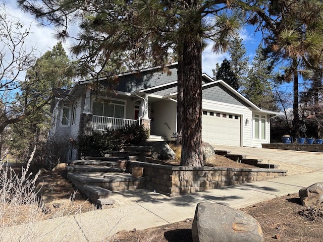 1746 W 14th Ave, Spokane, WA 99204 - view of front of house with a porch, an attached garage, and concrete driveway