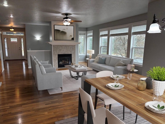 1746 W 14th Ave, Spokane, WA 99204 - living room featuring a ceiling fan, wood finished floors, a fireplace, and a textured ceiling