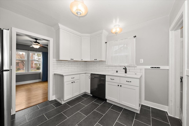 207 W 27th Ave, Spokane, WA 99203 - kitchen with dishwasher, light countertops, white cabinetry, and backsplash