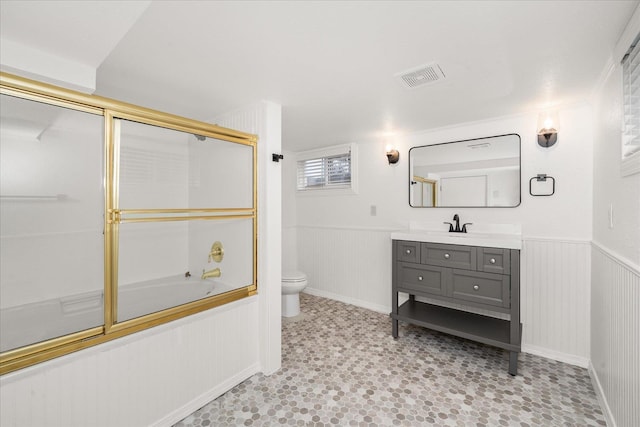 207 W 27th Ave, Spokane, WA 99203 - bathroom with vanity, shower / bath combination with glass door, and wainscoting
